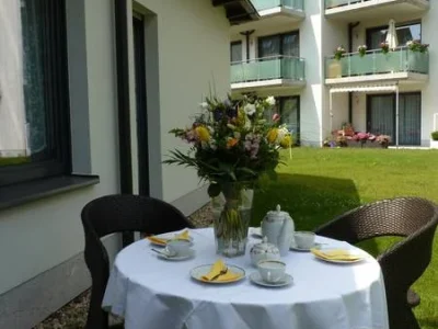 Gedeckter Kaffeetisch im Freien vor einem Haus